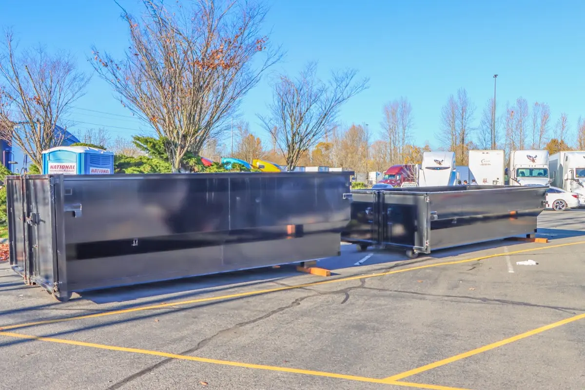 Professional dumpster rental service with roll-off container on residential driveway in Thomas